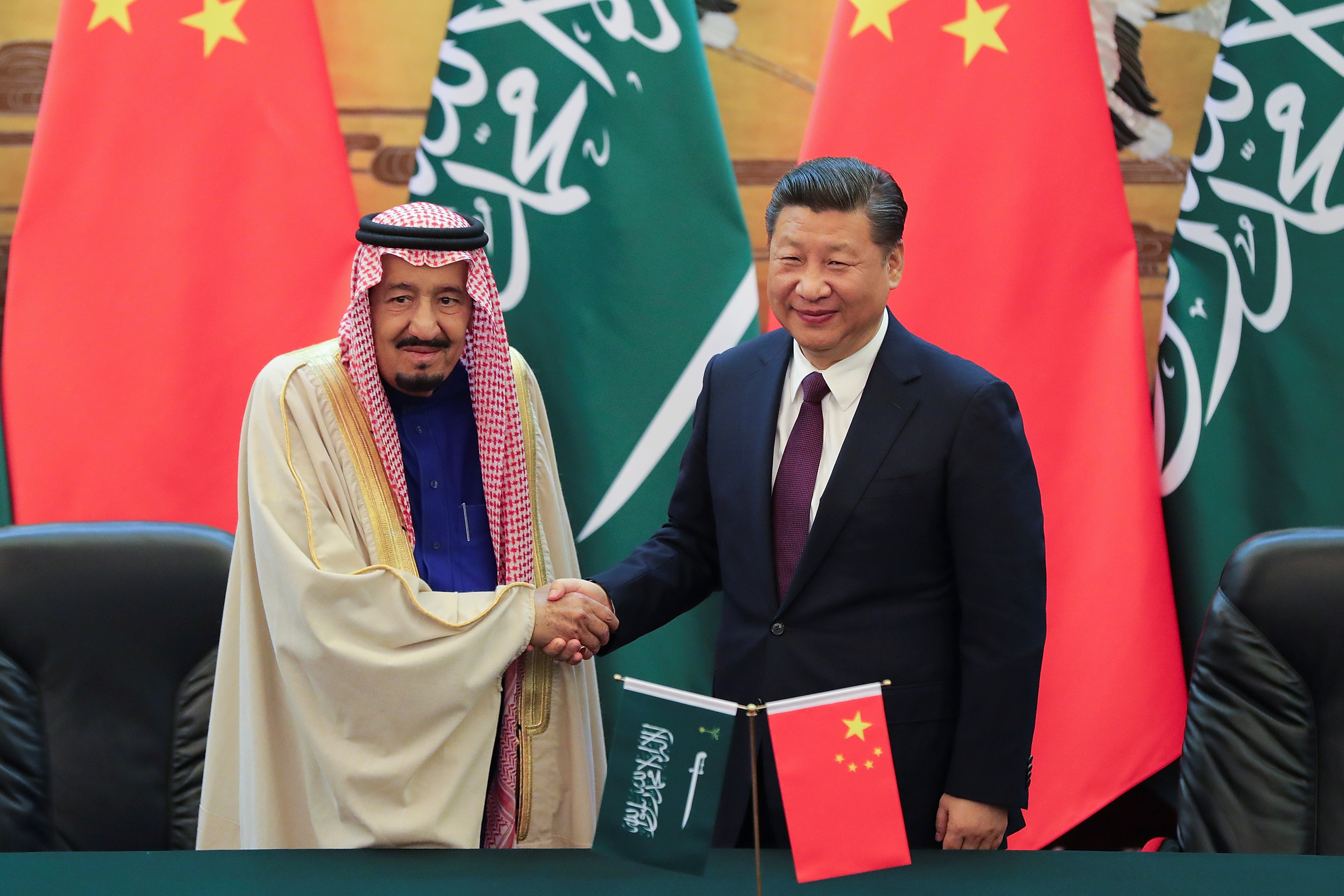 China's President Xi Jinping (R) and Saudi Arabia's King Salman bin Abdulaziz Al-Saud shake hands during a signing ceremony at the Great Hall of the People in Beijing, China March 16, 2017. REUTERS/Lintao Zhang/POOL