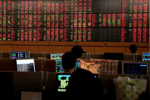 Traders are seen in front of a screen with trading figures in red at Thailand Stock Exchange building in Bangkok, Thailand March 13, 2020. REUTERS/Juarawee Kittisilpa