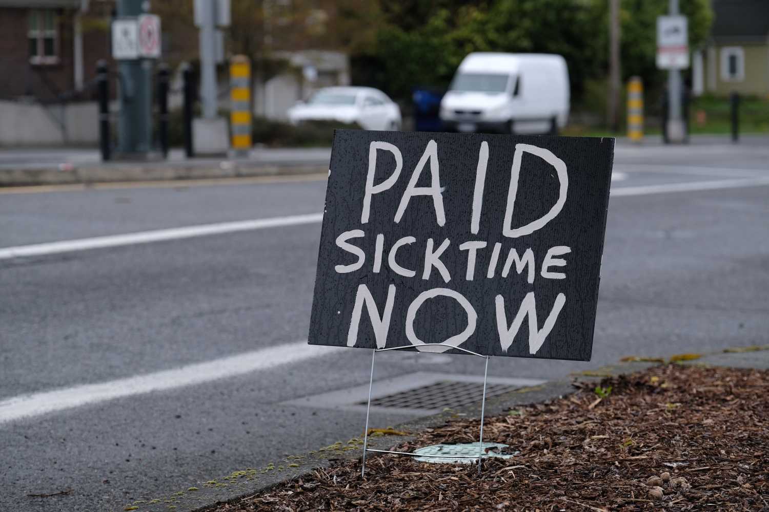 A sign calling for paid sick time pictured on North Interstate Avenue in Portland, Ore., on March 27, 2020, as the state continues to urge the importance of stricter social distancing measures to combat the novel coronavirus. (Photo by Alex Milan Tracy/Sipa USA)No Use UK. No Use Germany.