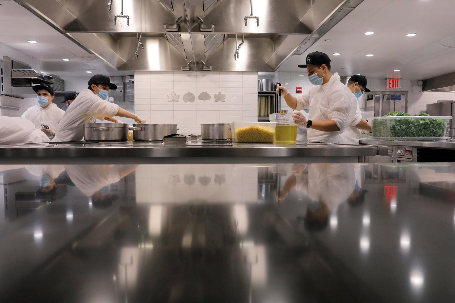 Kitchen staff work to create food donation boxes to give to needy families in the kitchen of Michelin starred restaurant Eleven Madison Park as the outbreak of the coronavirus disease (COVID19) continues in the Manhattan borough of New York, U.S., May 20, 2020.  Picture taken May 20, 2020. REUTERS/Lucas Jackson