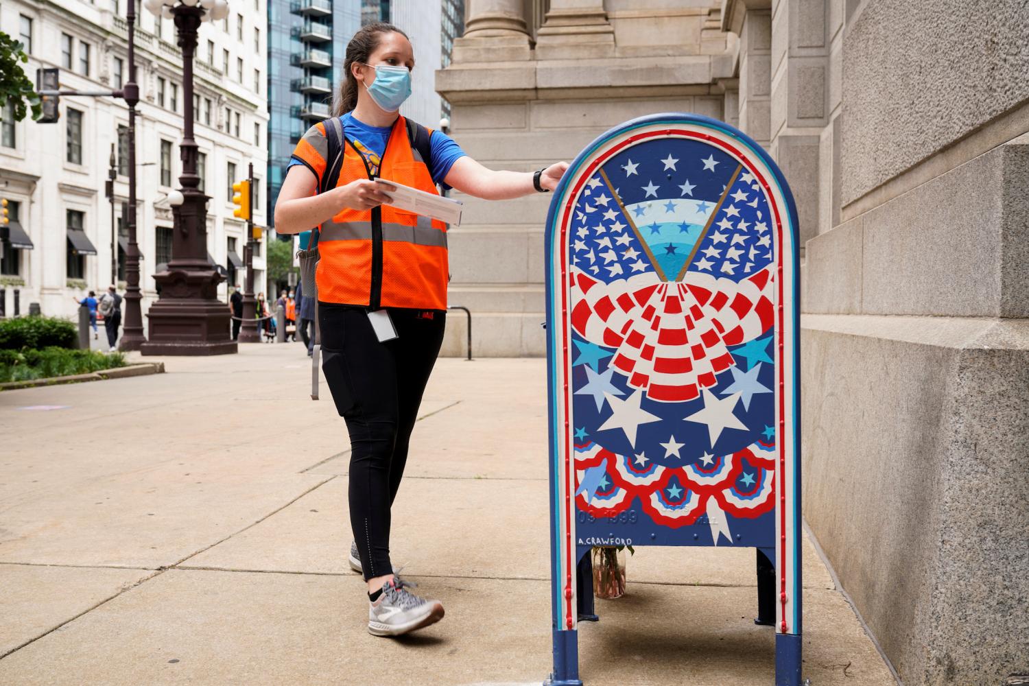 A woman wearing a mask to prevent the spread of coronavirus disease (COVID-19) casts her ballot in the primary election in Philadelphia, Pennsylvania, U.S., June 2, 2020.      REUTERS/Joshua Roberts