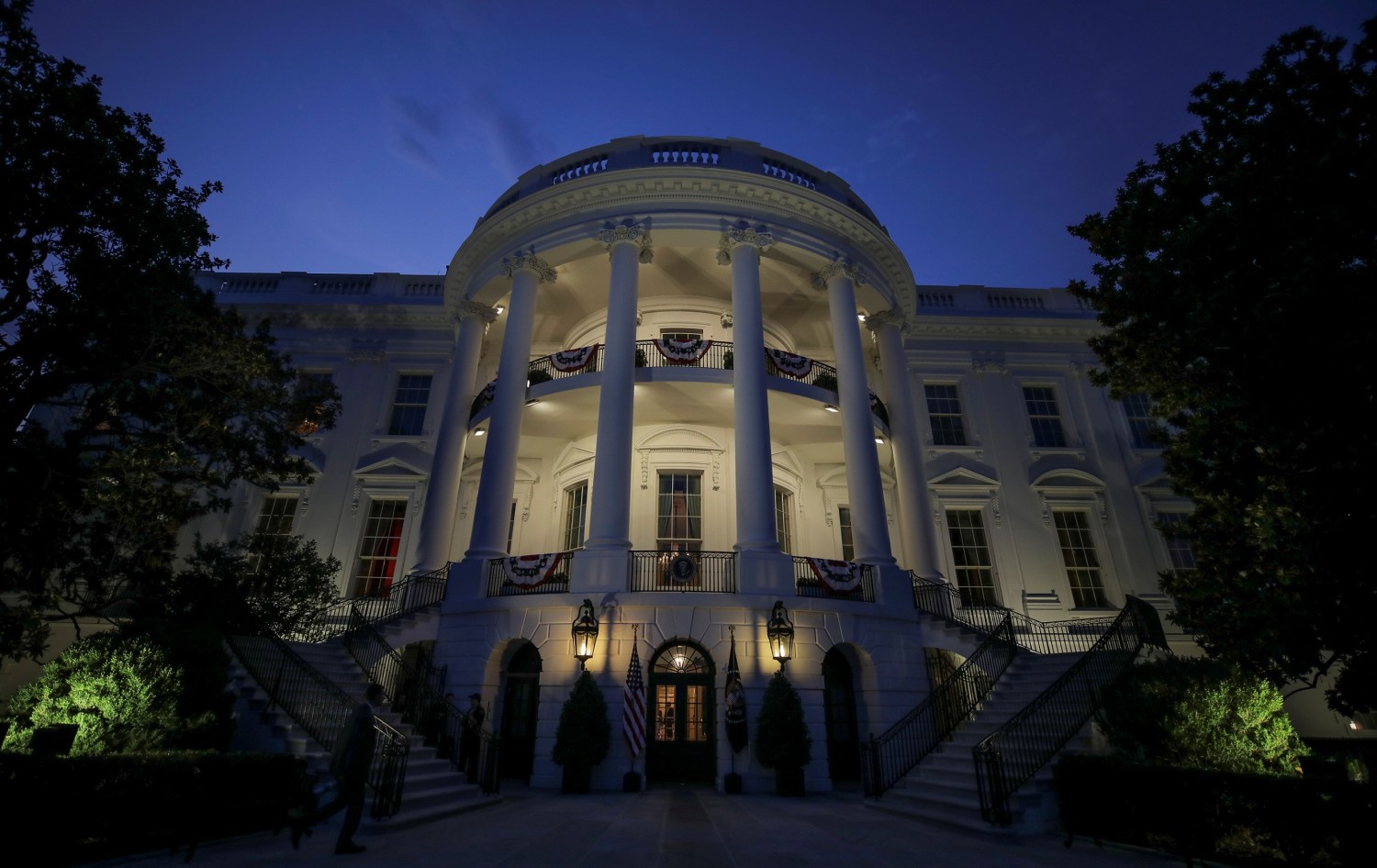 The South Portico and residence of the White House are illuminated before U.S. President Donald Trump and first lady Melania Trump emerged to watch the Washington, D.C. fireworks display from the Truman Balcony while celebrating the U.S. Independence Day holiday at the White House in Washington, U.S., July 4, 2020.   REUTERS/Carlos Barria