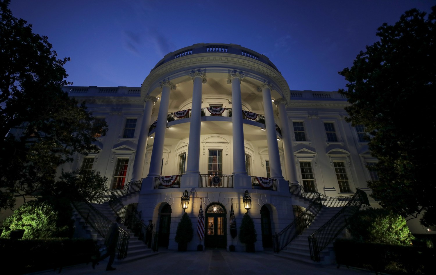 The South Portico and residence of the White House are illuminated before U.S. President Donald Trump and first lady Melania Trump emerged to watch the Washington, D.C. fireworks display from the Truman Balcony while celebrating the U.S. Independence Day holiday at the White House in Washington, U.S., July 4, 2020. REUTERS/Carlos Barria