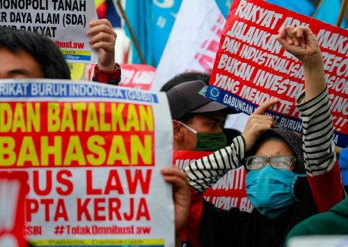 Members of Indonesian labor organizations protest outside the Indonesian Parliament against the cancellation of an "omnibus bill" that aims to revise dozens of existing laws in order to ease the way for investment in Southeast Asia's largest economy in Jakarta, Indonesia, July 16, 2020. REUTERS/Ajeng Dinar Ulfiana