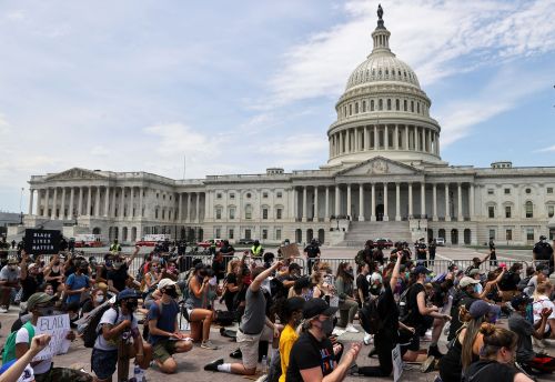 People take a knee during a Black Lives Matter rally, as protests continue over the death in Minneapolis police custody of George Floyd, outside the U.S. Capitol in Washington, U.S., June 3, 2020. REUTERS/Jonathan Ernst