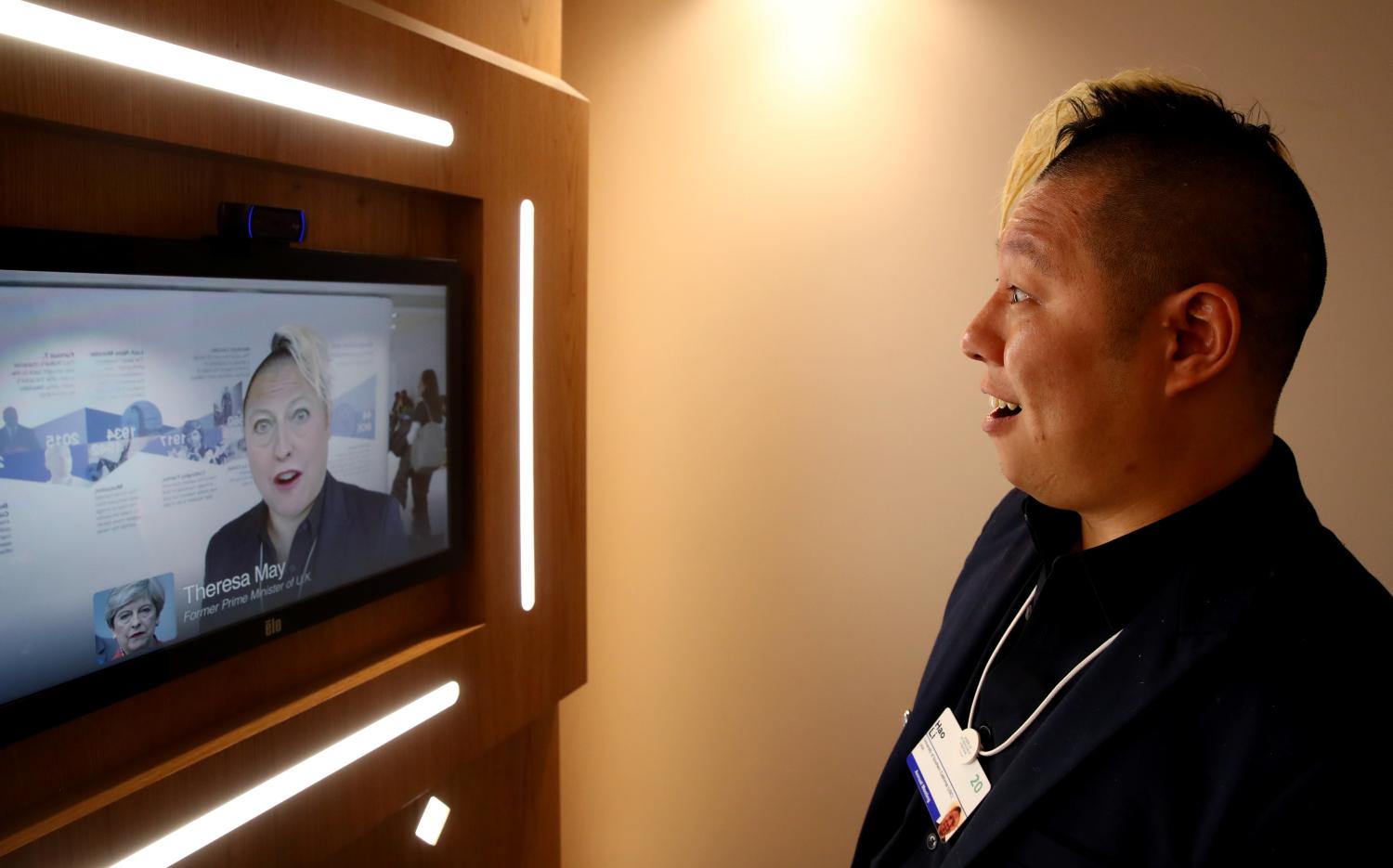 Associate professor of computer science at the University of Southern California Hao Li showcases a 'deepfake' video with Britain's former Prime Minister Theresa May during the 50th World Economic Forum (WEF) annual meeting in Davos, Switzerland, January 22, 2020. REUTERS/Denis Balibouse