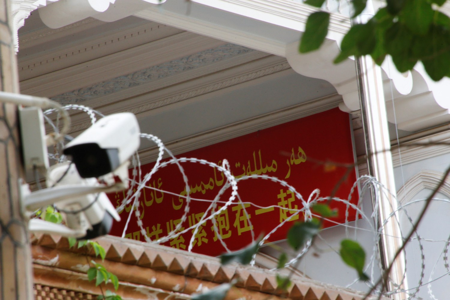 A propaganda banner and a security camera are placed on the walls of a mosque in the Old City in Kashgar, Xinjiang Uighur Autonomous Region, China September 6, 2018. Picture taken September 6, 2018.  To match Special Report MUSLIMS-CAMPS/CHINA  REUTERS/Thomas Peter