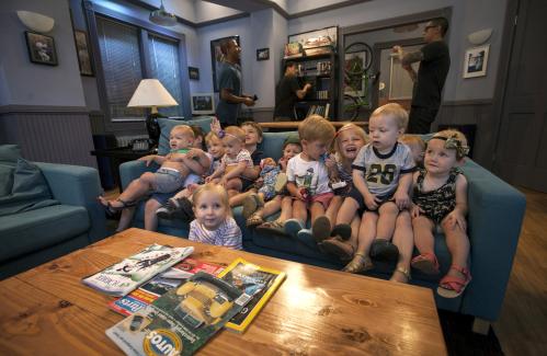 A group of children sit on a couch in a replica set from the "Seinfeld" television comedy series as they tour Hulu's "Seinfeld: The Apartment", a temporary exhibit on West 14th street in the Manhattan borough of New York City, June 24, 2015. Created to celebrate the launch of all of the episodes of the "Seinfeld" television comedy series available streaming on Hulu beginning June 24, the exhibit contains a replica version of the Upper West Side NewYork City apartment set from the series, original items and interactive elements and is open to the public through June 28.  REUTERS/Mike Segar