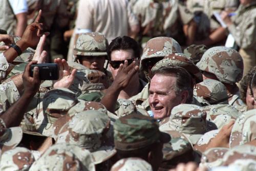 President George H.W. Bush is surrounded by a sea of U.S. military personnel as he greets troops following an arrival ceremony in the eastern Saudi Arabian city of Dhahran November 22, 1990. Bush celebrates Thanksgiving Day with U.S. troops from all branches of the military deployed here after the Iraqi invasion of Kuwait.   Reuters/Terry Bochatey ( SAUDI ARABIA - Tags: POLITICS CIVIL UNREST) BEST QUALITY AVAILABLE
