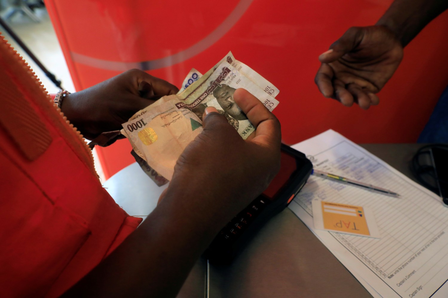 A cashier of the Lagos State Ferry Service (LAGFERRY) counts money from the boat ticket sales at the Five Cowries Terminal in Falomo Lagos, Nigeria February 10, 2020. Picture taken February 10, 2020. REUTERS/Temilade Adelaja