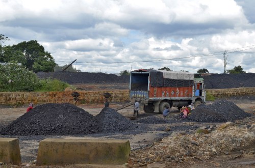 Labourers work at a coal stockyard in East Jaintia Hills in Meghalaya, India, September 16, 2015. A senior Indian politician has been lobbying New Delhi to lift a ban on dangerous, small-scale coal mining operations in his state, without disclosing that his wife owns several mines there, according to documents seen by Reuters. So-called "rat-hole" mining practised in Meghalaya state killed thousands of workers, including children, before the ban was imposed in April last year. At its peak the state produced coal worth $4 billion a year, or about a tenth of India's total production, nearly all from this form of small-scale mining. Picture taken September 16, 2015. REUTERS/Krishna N. Das