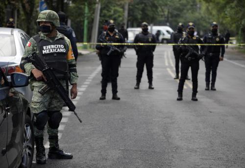A soldier stands near police officers guarding a crime scene following an assassination attempt of Mexico City's chief of police Omar Garcia Harfuch, at the upscale neighborhood of Lomas de Chapultepec, in Mexico City, Mexico June 26, 2020. REUTERS/Luis Cortes