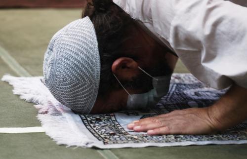 An Egyptian Muslim wearing a protective mask performs amid social distancing markers, first prayers of Al-Fajr prayer inside the Al Rahman Mosque after months of lockdown, following the outbreak of the coronavirus disease (COVID-19), in the Cairo neighborhood of Maadi, Egypt June 27, 2020. REUTERS/Amr Abdallah Dalsh