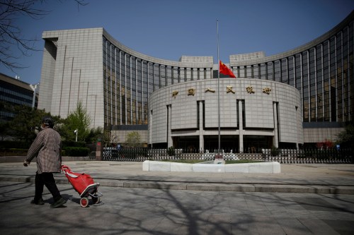 The Chinese national flag flies at half-mast at the headquarters of the People's Bank of China, the central bank (PBOC), as China holds a national mourning for those who died of the coronavirus disease (COVID-19), on the Qingming tomb-sweeping festival in Beijing, China April 4, 2020.  REUTERS/Carlos Garcia Rawlins     TPX IMAGES OF THE DAY
