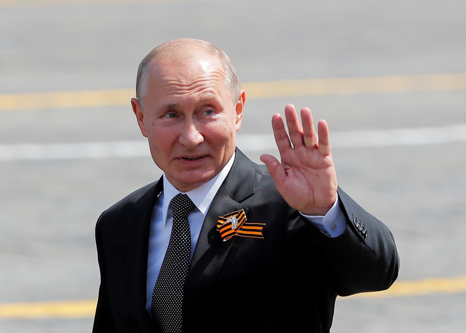 FILE PHOTO: Russia's President Vladimir Putin waves as he leaves after the Victory Day Parade in Red Square in Moscow, Russia June 24, 2020. The military parade, marking the 75th anniversary of the victory over Nazi Germany in World War Two, was scheduled for May 9 but postponed due to the outbreak of the coronavirus disease (COVID-19). REUTERS/Maxim Shemetov - RC2NFH9L23BA/File Photo