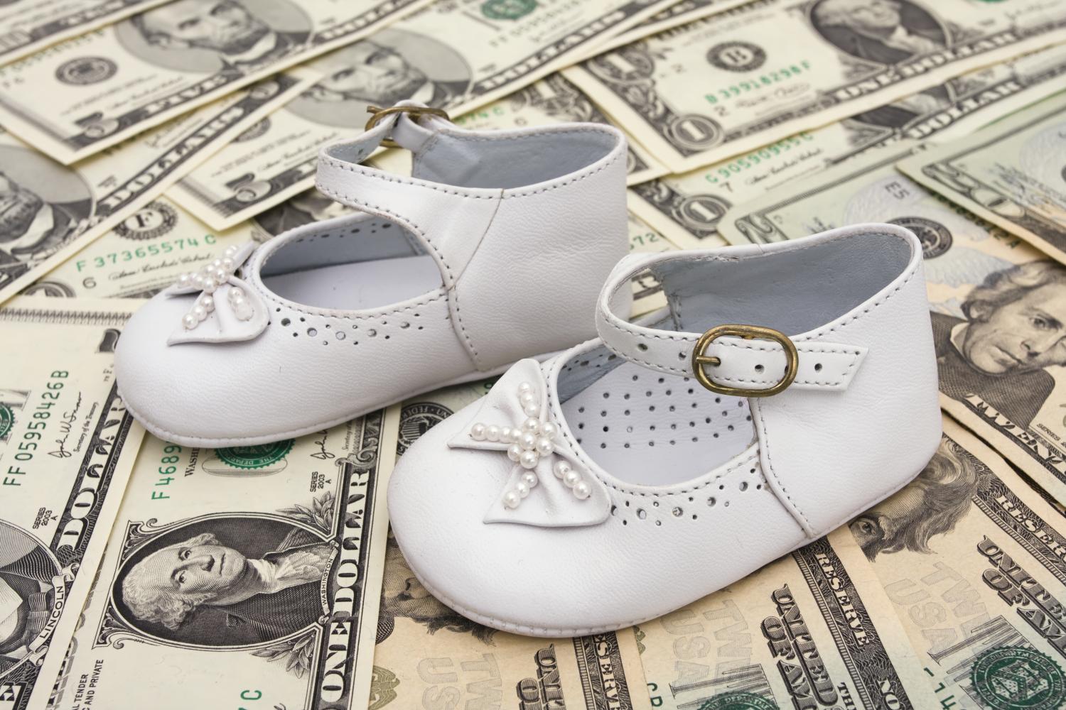 Baby shoes on top of money