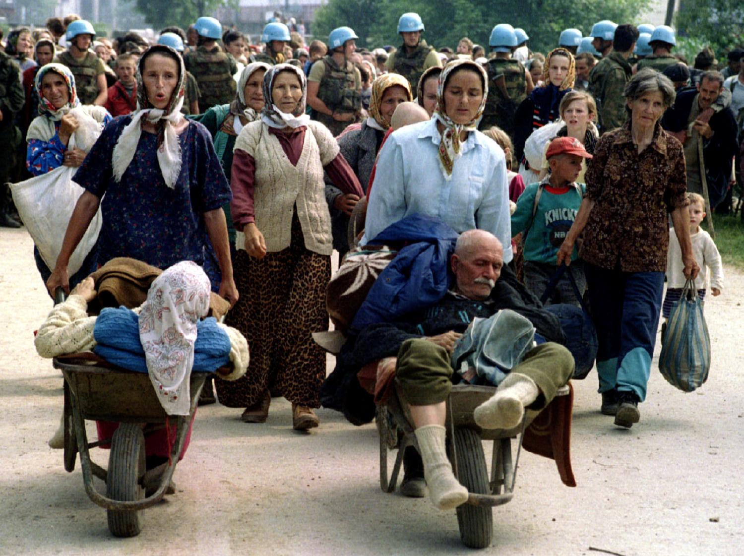 FILE PHOTO: Group of Bosnian refugees from Srebrenica, walk to be transported from eastern Bosnian village of Potocari to Kladanj near Olovo, July 13, 1995. Bosnia will mark the 25th anniversary of the massacre of more than 8,000 Bosnian Muslim men and boys on July 11, 2020, with many relatives unable to attend due to the novel coronavirus pandemic.  REUTERS/Stringer/File Photo