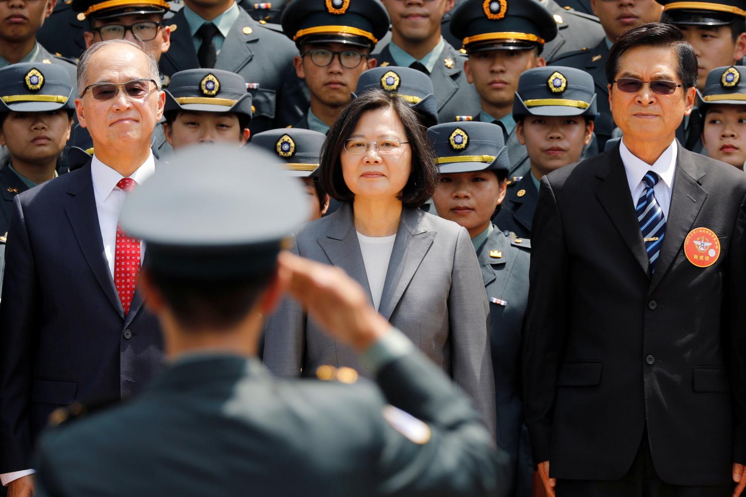 A soldier salutes (L-R) Director of the Institute for National Security Studies Feng Shih-kuan, Taiwanese President Tsai Ing-wen, and Minister of National Defense Yen Teh-fa after the joint military academies graduation ceremony, in Taipei, Taiwan June 29, 2018. REUTERS/Tyrone Siu