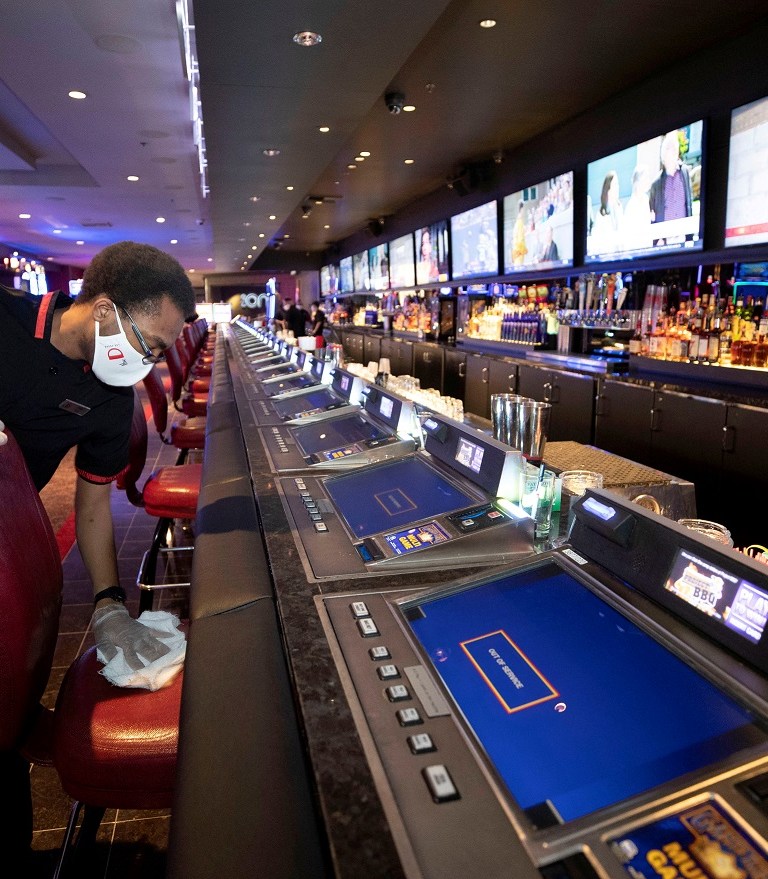 Chris Scott cleans a chair at the Long Bar as workers prepare for the June 4 reopening of The D hotel-casino, closed by the state since March 18, 2020 as part of steps to slow the spread of the coronavirus disease (COVID-19), in downtown Las Vegas, Nevada, U.S. June 3, 2020. REUTERS/Steve Marcus