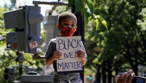 A child holds up a Black Lives Matter sign as people gather to protest the death in Minneapolis police custody of George Floyd, near the White House in Washington, U.S., June 7, 2020.      REUTERS/Joshua Roberts
