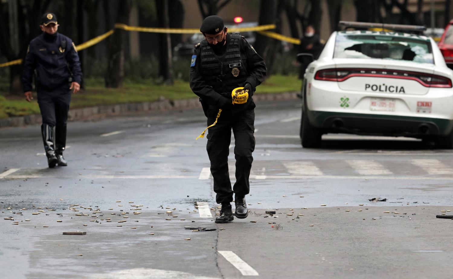 A police officer walks amid ammunition near the scene of a shooting in Mexico City, Mexico, June 26, 2020. REUTERS/Henry Romero