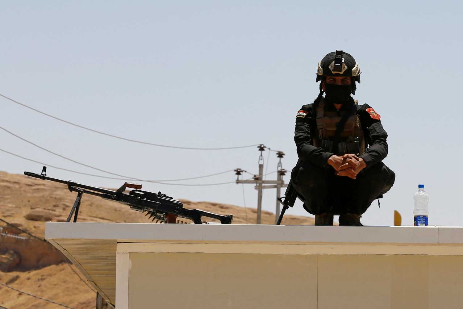 A member of Iraqi security forces is seen on the Iraqi side of Mandali border crossing between Iraq and Iran, in Mandali, Iraq July 11, 2020. REUTERS/Thaier al-Sudani/Pool