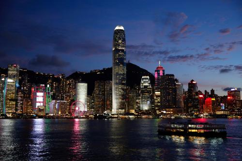 FILE PHOTO: A Star Ferry boat crosses Victoria Harbour in front of a skyline of buildings during sunset in Hong Kong, China June 29, 2020. REUTERS/Tyrone Siu/File Photo