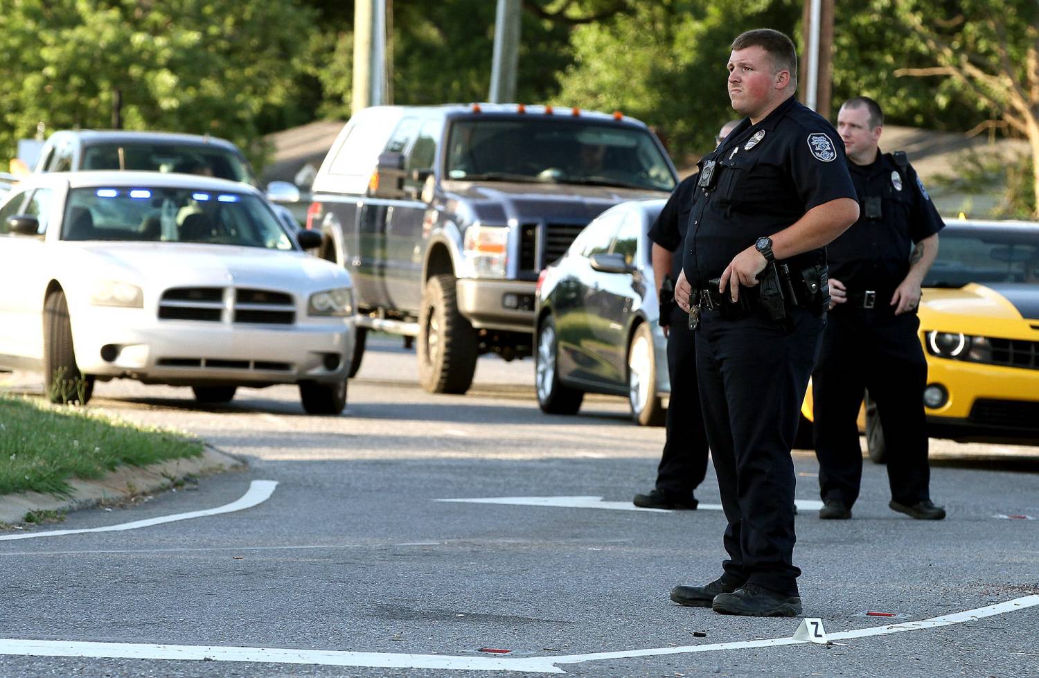 A Gastonia Police officer stands by a shell casing on New Hope Road near the scene of a shooting at the Ingco Express at 2741 Lowell Bethesda Road in Gastonia Tuesday evening.ghows_gallery-NC-610009996-cb496dee.jpg