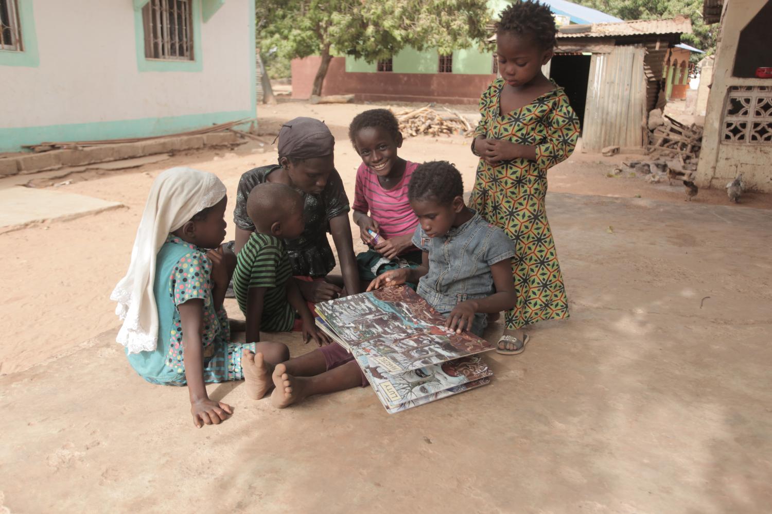 Students gather round and read a book