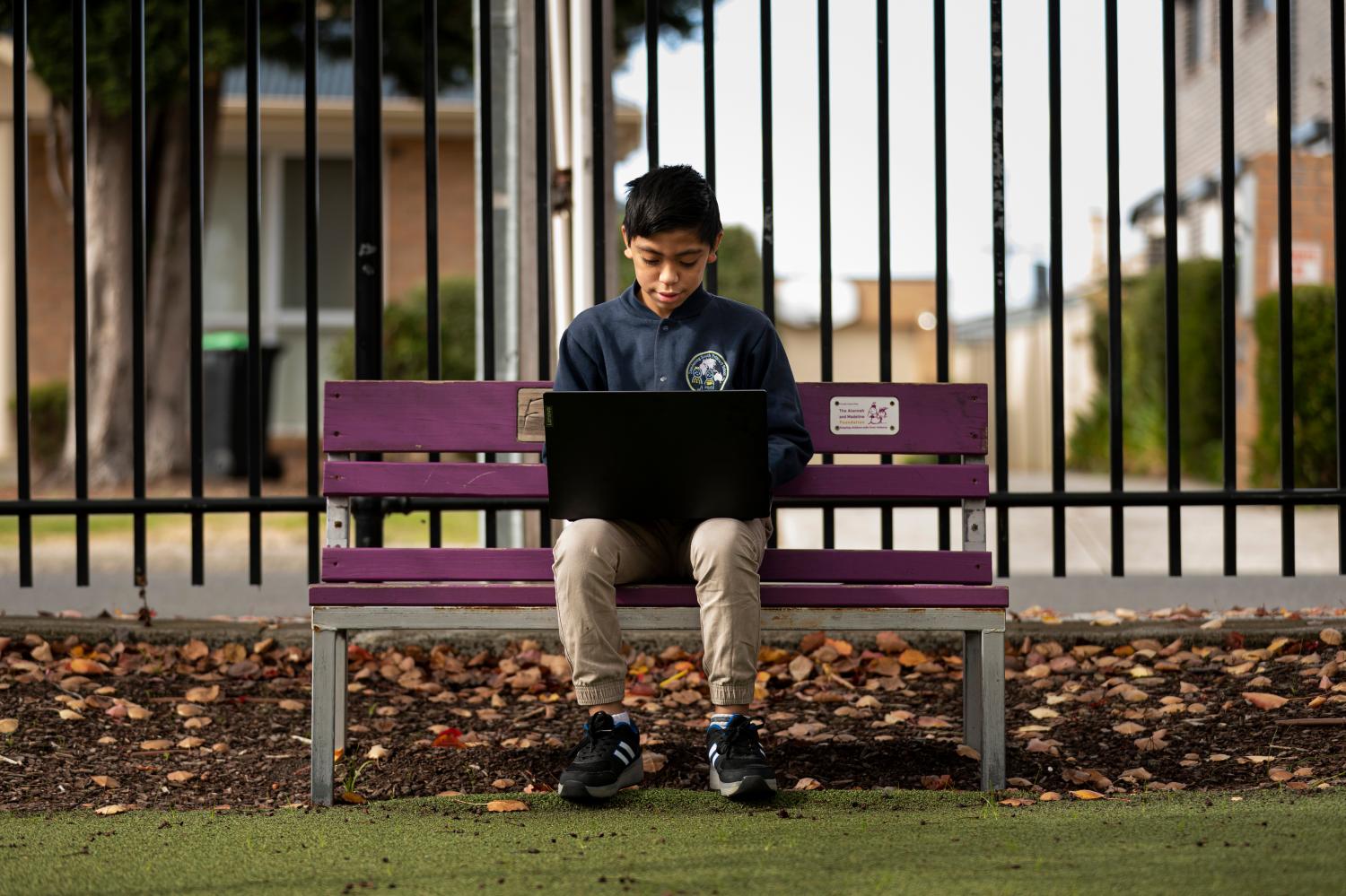 Lee Ausage tests out laptop he received from State Schools' Relief, at Dandenong South Primary School in Melbourne, Thursday, May 14, 2020. (AAP Image/Daniel Pockett) NO ARCHIVINGNo Use Australia. No Use New Zealand.