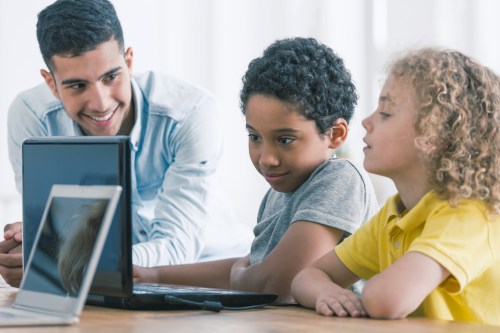 Children with teacher on a computer