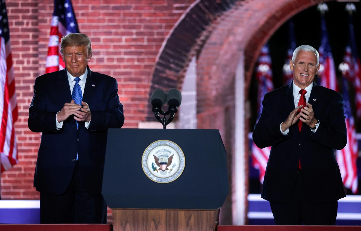 U.S. Vice President Mike Pence is joined onstage by U.S. President Donald Trump after delivering his acceptance speech as the 2020 Republican vice presidential nominee during an event of the 2020 Republican National Convention held at Fort McHenry in Baltimore, Maryland, U.S, August 26, 2020. REUTERS/Jonathan Ernst     TPX IMAGES OF THE DAY