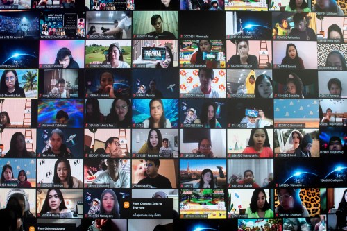 FILE PHOTO: Screens show audience via the Zoom application during the first six-hour online music festival at a studio amid the spread of the coronavirus disease (COVID-19) in Bangkok, Thailand, June 7, 2020. REUTERS/Athit Perawongmetha/File Photo