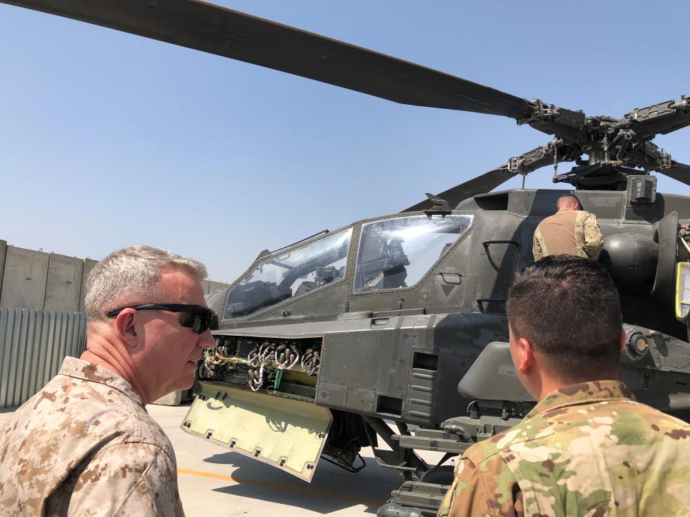 Marine General Kenneth McKenzie, head of U.S. Central Command, speaks with a U.S. soldier as they stand in front of a U.S. attack helicopter during a visit to Forward Operating Base Fenty in Jalalabad, Afghanistan, September 9, 2019. REUTERS/Phil Stewart