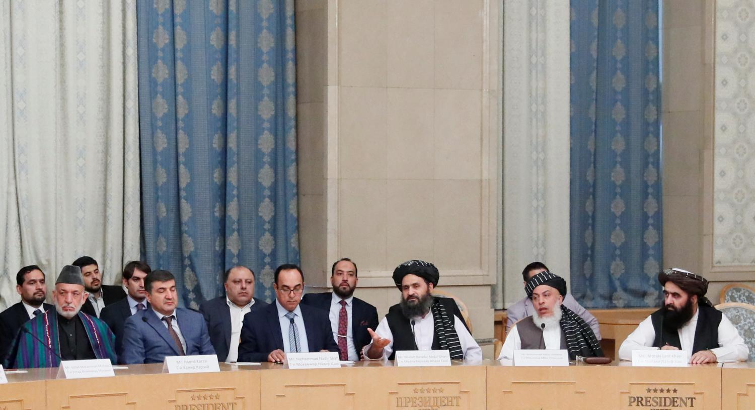 Officials, including Afghan former President Hamid Karzai (L), Head of Political Office of Taliban Mohammad Abbas Stanikzai (2nd R) and Taliban chief negotiator Mullah Abdul Ghani Baradar (3rd R), attend peace talks in Moscow, Russia May 30, 2019. REUTERS/Evgenia Novozhenina