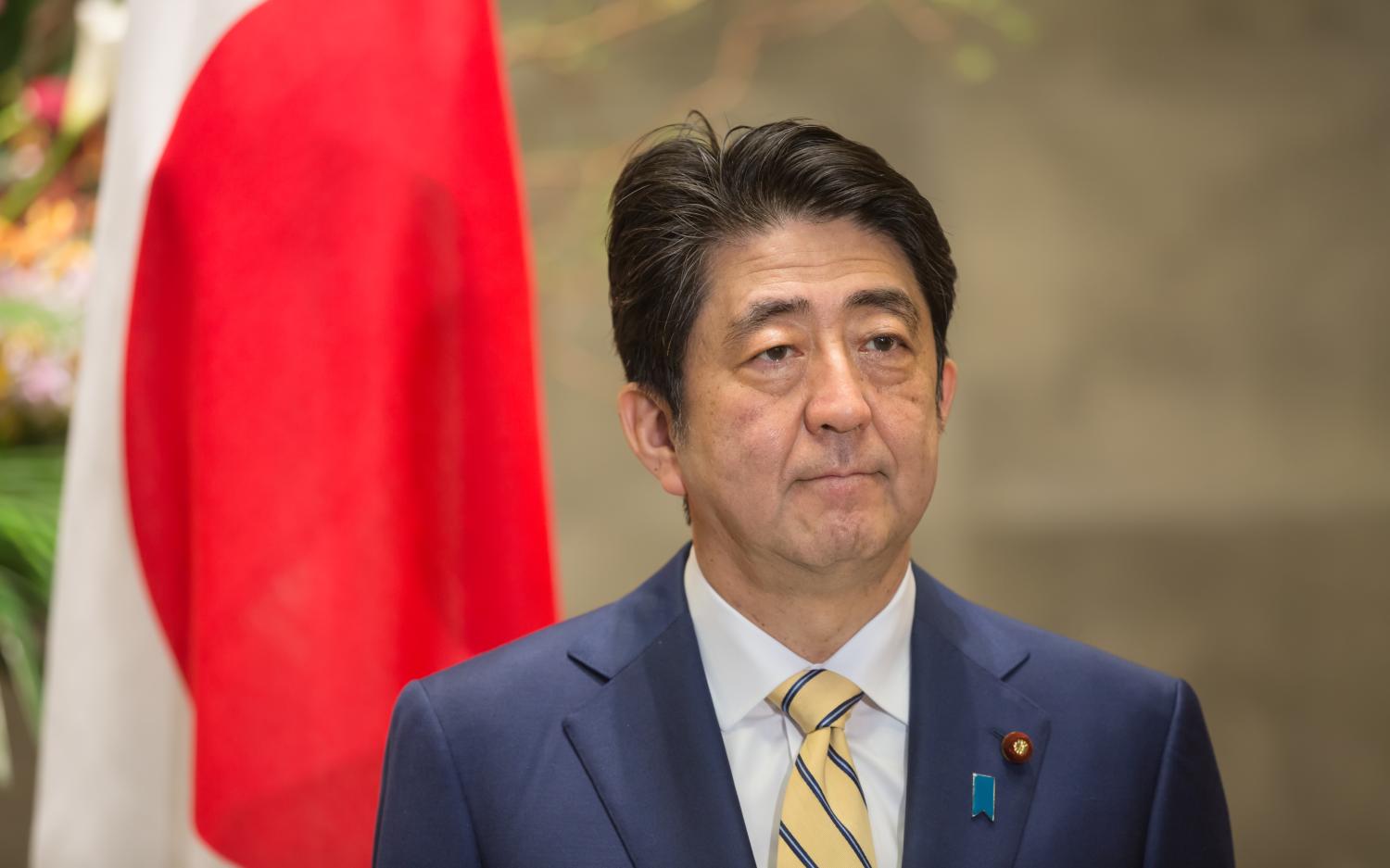 Image: PM Shinzo Abe in front of Japanese flag