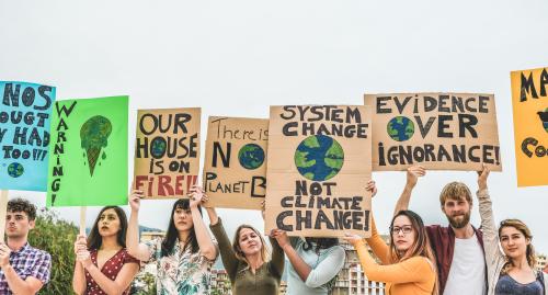 Young people holding signs protesting climate change