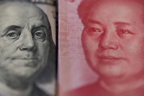 $100 bill and 100 renminbi bills