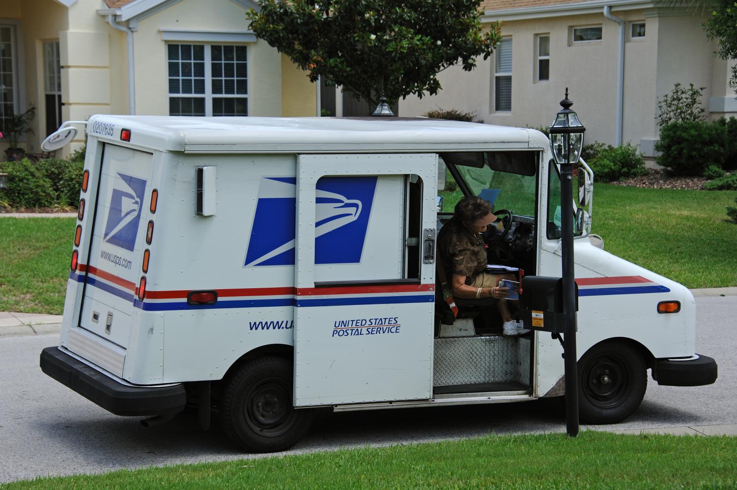 US POST VEHICLE IN SUMMERFIELD FLORIDA USA - CIRCA 2014 -United States Postal Service collection and delivery van on a residential complex in Summerfield Florida USA