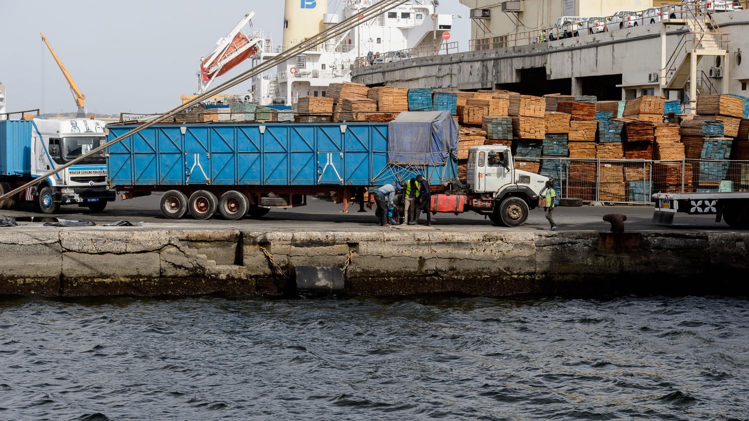 DAKAR, SENEGAL - APR 23, 2017: Unidentified Senegalese people stand in front of the truck at the port of Dakar, the capital of Senegal