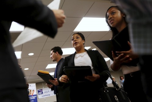 Job seekers listen to prospective employers during a job hiring event for marketing, sales and retail positions in San Francisco, California, in this file photo taken June 4, 2015. The number of Americans filing new claims for unemployment benefits fell more than expected last week, pointing to a tightening labor market.  REUTERS/Robert Galbraith/Files