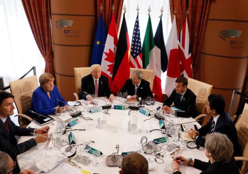 (L-R) Canadian Prime Minister Justin Trudeau, German Chancellor Angela Merkel, U.S. President Donald Trump, Italian Prime Minister Paolo Gentiloni, French President Emmanuel Macron, Japanese Prime Minister Shinzo Abe, Britain’s Prime Minister Theresa May, European Council President Donald Tusk and European Commission President Jean-Claude Juncker sit around a table during the G7 Summit in Taormina, Sicily, Italy, May 26, 2017. REUTERS/Jonathan Ernst