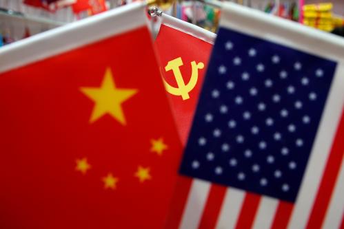 The flags of China, U.S. and the Chinese Communist Party are displayed in a flag stall at the Yiwu Wholesale Market in Yiwu, Zhejiang province, China, May 10, 2019. REUTERS/Aly Song