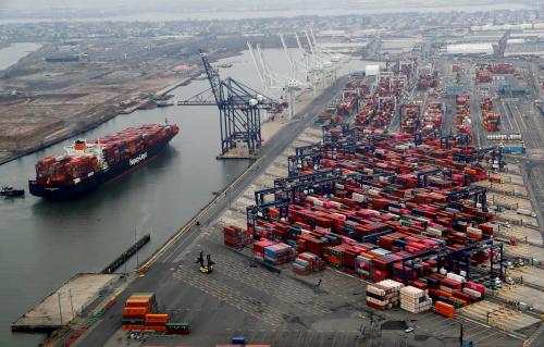 A container ship is seen as hundreds of shipping containers are seen stacked at a pier at the Port of New York and New Jersey in Elizabeth, New Jersey, U.S., March 30, 2020. REUTERS/Mike Segar