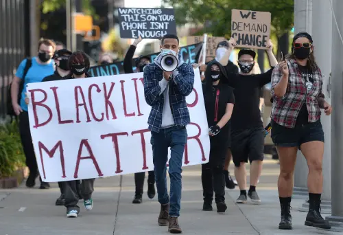 Aug 29, 2020; Erie, PA, USA; Erie Equal founder Andrey Rosado, center, leads protesters as they march past Erie City Hall during the We Will Not Stay Silent rally on Aug. 29, 2020. The rally, organized by Erie Equal, was in response to the social unrest and violence in Kenosha, Wisconsin and other cites across the country. Mandatory Credit: Jack Hanrahan/Erie Times-News-USA TODAY NETWORK