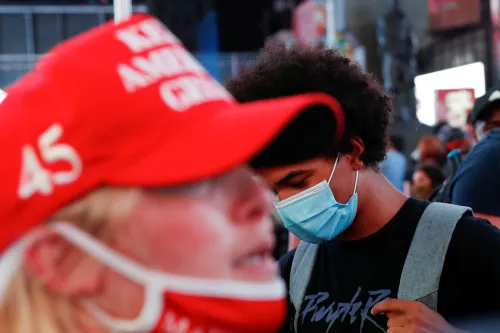 A supporter of U.S. President Donald Trump is seen as a demonstrator wearing a face mask attends a protest following the death of the Black man Daniel Prude, after police put a spit hood over his head during an arrest in Rochester on March 23, at Times Square in New York, U.S. September 3, 2020. REUTERS/Shannon Stapleton