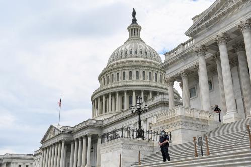 FILE PHOTO: Police officers wearing face masks guard the U.S. Capitol Building in Washington, U.S., May 14, 2020. REUTERS/Erin Scott/File Photo
