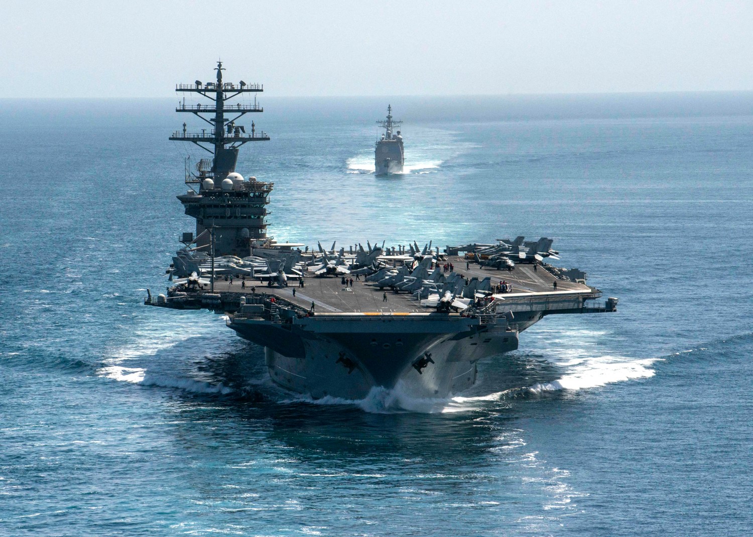 Photo dated September 18, 2020 of the aircraft carrier USS Nimitz (CVN 68) and the guided-missile cruiser USS Philippine Sea (CG 58) steam in formation during a Strait of Hormuz transit. The Nimitz aircraft carrier passed the Strait of Hormuz uneventfully to enter the Gulf Friday, the Navy announced. A strike group led by the USS Nimitz and including two guided-missile cruisers and a guided-missile destroyer sailed into the Gulf to operate and train with US partners and support the coalition fighting the Islamic State (ISIS) group, the US 5th Fleet added in a statement. The Nimitz, Americas oldest carrier in active service, carries some 5,000 sailors and Marines. U.S. Navy photo by Mass Communication Specialist 3rd Class Elliot Schaudt via ABACAPRESS.COM