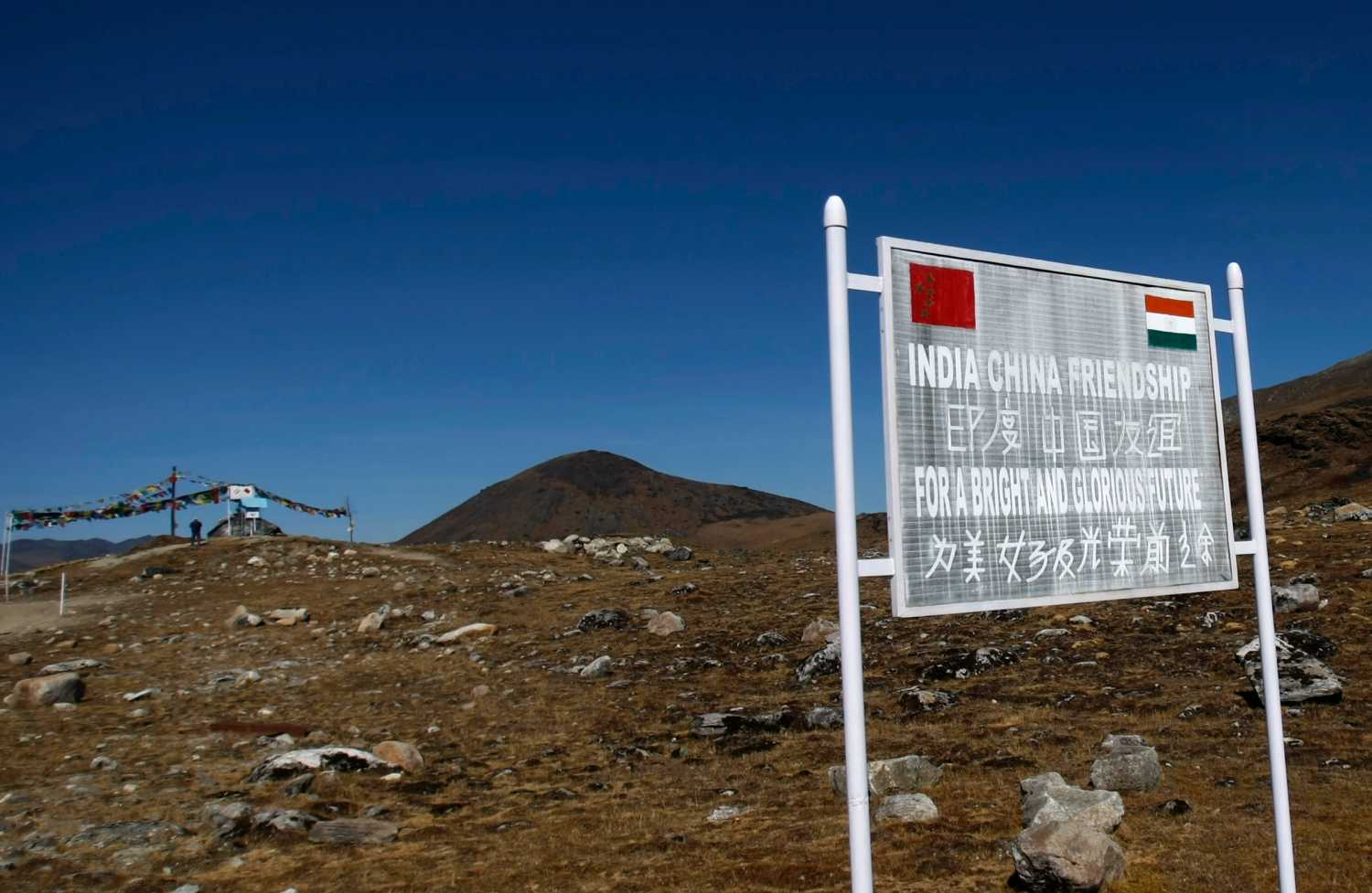 A signboard is seen from the Indian side of the Indo-China border at Bumla, in the northeastern Indian state of Arunachal Pradesh, November 11, 2009. With ties between the two Asian giants strained by a flare-up over their disputed boundary, India is fortifying parts of its northeast, building new roads and bridges, deploying tens of thousands more soldiers and boosting air defences. Picture taken November 11, 2009.   REUTERS/Adnan Abidi (INDIA POLITICS MILITARY) - GM1E5BD1BOA01