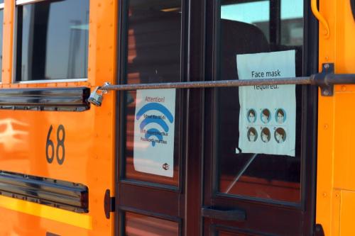 Flyers are posted on the doors of Deming Public School bus 68 near the Mexican border in Columbus, NM. The flyers give students the username and password for internet access and also remind students to wear masks.Bus2